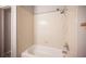 The bathroom features a clean bathtub, tiled walls and chrome shower fixtures at 7911 Canoe Ln, Las Vegas, NV 89145