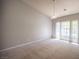 This room boasts neutral carpet, a hanging light fixture, and a large window at 7911 Canoe Ln, Las Vegas, NV 89145