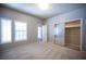 Bright bedroom with plush carpet, neutral paint, large closet, and natural light at 7911 Canoe Ln, Las Vegas, NV 89145