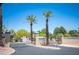 A gated community entrance with palm trees at 7911 Canoe Ln, Las Vegas, NV 89145