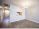 Dining room with hardwood floors, neutral paint, view to kitchen and hallway at 7911 Canoe Ln, Las Vegas, NV 89145