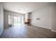 Open living room featuring hardwood floors, fireplace, neutral paint and sliding glass door leading to the backyard at 7911 Canoe Ln, Las Vegas, NV 89145