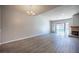Bright living room with hardwood floors, neutral paint, a fireplace, and sliding glass door leading to the backyard at 7911 Canoe Ln, Las Vegas, NV 89145