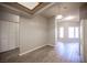 Open-concept living area with laminate flooring, neutral paint, and a smooth transition to the kitchen at 7911 Canoe Ln, Las Vegas, NV 89145