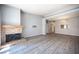 Hardwood floors and neutral paint in spacious living room featuring brick fireplace at 7911 Canoe Ln, Las Vegas, NV 89145