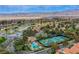 Expansive aerial view of community with golf course, lake, and mountain views on clear day at 7940 Castle Pines Ave, Las Vegas, NV 89113