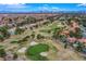 Overhead shot of neighborhood, highlighting golf course and city views in the background at 7940 Castle Pines Ave, Las Vegas, NV 89113