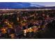 Nighttime aerial view showcasing the community with city lights and mountain backdrop in the distance at 7940 Castle Pines Ave, Las Vegas, NV 89113