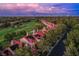Breathtaking aerial shot featuring well-maintained homes with a golf course and city skyline in the distance at 7940 Castle Pines Ave, Las Vegas, NV 89113