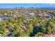 An aerial view of a residential area with lush trees and mountain views at 7940 Castle Pines Ave, Las Vegas, NV 89113