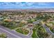 An aerial view of a community with mature landscaping, a lake, and mountains in the distance at 7940 Castle Pines Ave, Las Vegas, NV 89113