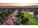 Stunning aerial view of homes on a lush golf course with a serene lake and mountain backdrop at 7940 Castle Pines Ave, Las Vegas, NV 89113