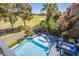 Stunning aerial view of a luxurious pool and patio area adjacent to a verdant golf course at 7940 Castle Pines Ave, Las Vegas, NV 89113