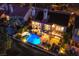 Aerial view of a home with a private pool, lounge area, and outdoor dining at twilight at 7940 Castle Pines Ave, Las Vegas, NV 89113