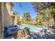 Stunning backyard with a pool, stylish patio furniture, and lush landscaping at 7940 Castle Pines Ave, Las Vegas, NV 89113