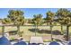 Scenic view from the balcony overlooking the lush green golf course and mature trees at 7940 Castle Pines Ave, Las Vegas, NV 89113