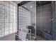 Modern bathroom with a glass block window and tiled shower with built-in seat at 7940 Castle Pines Ave, Las Vegas, NV 89113