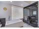 Modern bathroom features a freestanding tub, glass block window, and a walk-in shower with stylish tile at 7940 Castle Pines Ave, Las Vegas, NV 89113