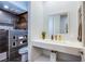 Modern bathroom featuring a floating vanity with sleek fixtures and a walk-in shower with dark tile and built-in shelves at 7940 Castle Pines Ave, Las Vegas, NV 89113