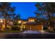 Inviting two-story home featuring a well-manicured lawn, mature trees and a convenient two-car garage at 7940 Castle Pines Ave, Las Vegas, NV 89113