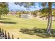 Scenic view of a golf course with trees, water features, and mountains in the distance at 7940 Castle Pines Ave, Las Vegas, NV 89113