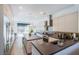 Sleek modern kitchen with stainless steel appliances and island with bar seating at 7940 Castle Pines Ave, Las Vegas, NV 89113