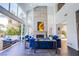 Bright and airy living room features a fireplace, large windows and stylish blue sofas at 7940 Castle Pines Ave, Las Vegas, NV 89113