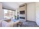 Modern living room with a tiled fireplace and large sliding glass door for ample natural light at 7940 Castle Pines Ave, Las Vegas, NV 89113