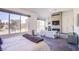 Bright main bedroom features a sleek fireplace, comfortable seating, and large windows with golf course views at 7940 Castle Pines Ave, Las Vegas, NV 89113