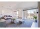 Spacious main bedroom with large windows, a comfortable seating area, and access to a private balcony at 7940 Castle Pines Ave, Las Vegas, NV 89113