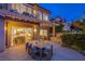 Inviting outdoor patio with dining area and grill, perfect for entertaining in the evening at 7940 Castle Pines Ave, Las Vegas, NV 89113