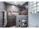 Stylish shower with modern fixtures, built-in shelving, and a glass block window for natural light at 7940 Castle Pines Ave, Las Vegas, NV 89113