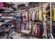 Well-organized walk-in closet with comprehensive shelving, hanging space, and seating for convenience at 7940 Castle Pines Ave, Las Vegas, NV 89113