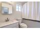 Small bathroom featuring a modern sink, mirror, toilet and shower with a striped curtain at 7964 Lovely Pine Pl, Las Vegas, NV 89143