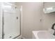 Bathroom featuring shower with glass door, vanity with white countertop and sink, and light walls at 7964 Lovely Pine Pl, Las Vegas, NV 89143