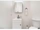 Clean half bathroom with sleek sink, modern vanity, and stylish decorative mirror at 7964 Lovely Pine Pl, Las Vegas, NV 89143