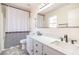 Bathroom features vanity with double sinks, a stylish mirror, and shower-tub combo at 7964 Lovely Pine Pl, Las Vegas, NV 89143