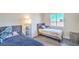Bright bedroom featuring two beds, a window, modern floors, and decor at 7964 Lovely Pine Pl, Las Vegas, NV 89143