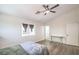 Bedroom featuring high ceilings, wood-look flooring, a ceiling fan, and a window at 7964 Lovely Pine Pl, Las Vegas, NV 89143