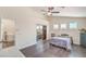 Bright bedroom with wood-look floors, ceiling fan, and mirrored closet at 7964 Lovely Pine Pl, Las Vegas, NV 89143