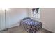 This cozy bedroom is staged with a modern light fixture and a window at 7964 Lovely Pine Pl, Las Vegas, NV 89143