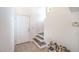 Clean entryway featuring tile flooring, stairs to the second floor and a shoe rack at 7964 Lovely Pine Pl, Las Vegas, NV 89143