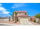 Charming two-story home featuring desert landscaping, a palm tree, and a two-car garage at 7964 Lovely Pine Pl, Las Vegas, NV 89143