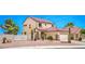 Charming two-story home showcasing a desert landscape, gated yard, and attached garage at 7964 Lovely Pine Pl, Las Vegas, NV 89143
