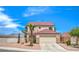 Charming two-story home featuring desert landscaping, a palm tree, and a two-car garage at 7964 Lovely Pine Pl, Las Vegas, NV 89143