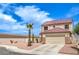 Charming two-story home featuring desert landscaping, a palm tree, and a two-car garage at 7964 Lovely Pine Pl, Las Vegas, NV 89143