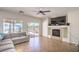 Spacious living room featuring tile flooring, a fireplace, and sliding doors to the backyard at 7964 Lovely Pine Pl, Las Vegas, NV 89143
