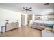 Bright living area with tile flooring, ceiling fan, and seamlessly connects to the modern kitchen at 7964 Lovely Pine Pl, Las Vegas, NV 89143