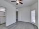 This bedroom features gray floors, a ceiling fan, and access to an ensuite bathroom and private balcony at 8250 N Grand Canyon Dr # 2001, Las Vegas, NV 89166