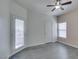 This bedroom features gray floors, a ceiling fan, and a door leading to a private balcony at 8250 N Grand Canyon Dr # 2001, Las Vegas, NV 89166